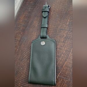 Dark green coach luggage tag
